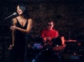 Jazz band performance. Couple of musicians - a drummer and a singer in a nightclub. Royalty Free Stock Photo