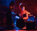 Jazz band performance. Couple of musicians - a drummer and a singer in a nightclub. Royalty Free Stock Photo