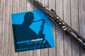 Jazz bebop vinyl cover from the 60s on wooden surface with sax instrument