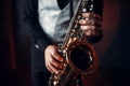 Jazz man hands holding saxophone closeup Royalty Free Stock Photo