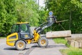 JCB compact loader lifts and transports a concrete block Royalty Free Stock Photo