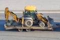 JCB 3CX machinery a tractor bucket back and front for digging is transported trailer platform truck highway. Russia, Saint-