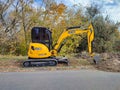 JCB digger or excavator performs excavation work outdoors Royalty Free Stock Photo