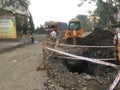 JCB digging machine on working on road digging for pipe line at Lokgram