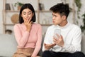 Jealous Chinese Husband Showing Cheating Wife Her Cellphone At Home Royalty Free Stock Photo