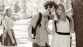 Jealous girl looking at flirting couple outdoor. Royalty Free Stock Photo