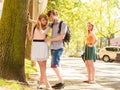 Jealous girl looking at flirting couple outdoor. Royalty Free Stock Photo