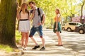 Jealous girl looking at flirting couple outdoor. Royalty Free Stock Photo