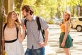 Jealous girl looking at flirting couple outdoor Royalty Free Stock Photo