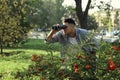 Jealous man with binoculars spying on ex girlfriend in park Royalty Free Stock Photo