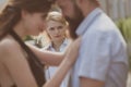 A jealous wife. Unhappy girl feeling jealous. Romantic couple of man and woman dating. Bearded man cheating his Royalty Free Stock Photo
