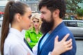 Jealous woman look at couple in love on street. Really jealous of him. Romantic couple of man and woman dating. Bearded Royalty Free Stock Photo