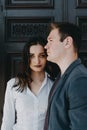 Jealousy concept. Young couple outdoor portrait. Girl got mad at boyfriend. Woman looks suspiciously at man Royalty Free Stock Photo