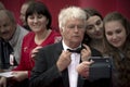 Jean Jacques Annaud with fans makes selfie on the red carpet before the opening 37 of the Moscow International film Festival