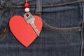 Jeans background with wooden heart and key..Valentine's day. Royalty Free Stock Photo