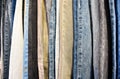 Jeans in blue and various colors arranged in vertical rows