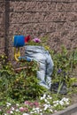 Jeans and boots as flowerpots in the spring garden, closeup. Garden decoration idea