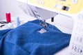Jeans Fabric On Sewing Machine Under Sewn Foot. Royalty Free Stock Photo