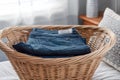 Jeans folded in laundry basket Royalty Free Stock Photo