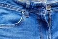 Jeans front with zipper open, button and pocket. Bright blue denim fabric texture background Royalty Free Stock Photo