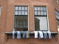 Jeans hanging to dry outside the window in the street