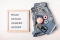 Jeans with letter board and text wear, repair, remake, repeat