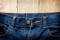 Jeans on old wooden surface background, empty space for texture Royalty Free Stock Photo