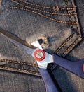 Jeans with a pair of scissors in his pocket