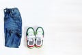 Jeans pants with sneakers. Set of baby children`s clothes and accessories for spring, autumn or summer on white background. Royalty Free Stock Photo