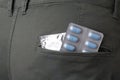 Jeans with pills and condom in pocket, closeup. Potency problem Royalty Free Stock Photo