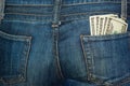 Jeans rear pocket with $100 banknotes