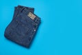 Jeans with recycling label on light blue background, top view. Space for text Royalty Free Stock Photo
