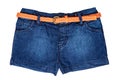 Jeans shorts isolated. Trendy stylish short jeans pants with orange leather belt for child girl isolated on a white background. Royalty Free Stock Photo