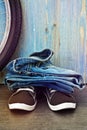 Jeans and sneakers on a background of blue wooden fence Royalty Free Stock Photo