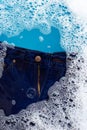 Jeans soak in powder detergent water dissolution. Laundry concept