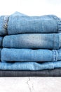 jeans are stacked on a white background. stack of several fashionable women`s or teenage casual all-season denim pants clothing b