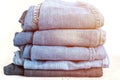 jeans are stacked on a white background. stack of several fashionable women`s or teenage casual all-season denim pants clothing b