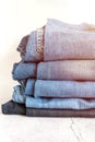 jeans are stacked on a white background. stack of several fashionable women`s or teenage casual all-season denim pants clothing b