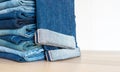 Jeans trousers stack on white background Royalty Free Stock Photo