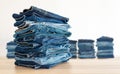Jeans trousers stack on white background. Royalty Free Stock Photo
