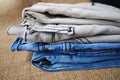 Jeans trousers stack on white background. Royalty Free Stock Photo