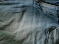 Jeans in wash blue with rip. Denim background, texture. Ripped. Organic, design. Royalty Free Stock Photo