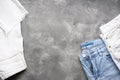 Jeans for women, denim pants on a gray background, top view. Space for text