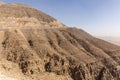 Jebel Jais mountain peak with winding tarmac road cutting the slope and zipline above, United Arab Emirates