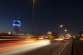 Jeddah water tower at night, with car lights motion