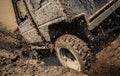 Jeep car splashing in muddy terrain