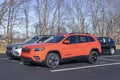 Jeep Cherokee SUV display at a Stellantis Jeep dealer. The Cherokee models include the Freedom, Latitude and Trailhawk