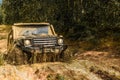 Jeep crashed into a puddle and picked up a spray of dirt. Off road sport truck between mountains landscape. Track on mud Royalty Free Stock Photo