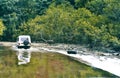 A jeep crossing river between the forest in Goa India