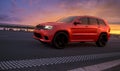 Jeep Grand Cherokee Trackhawk on the road during a spectacular sunset